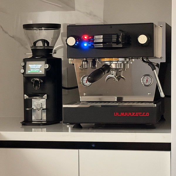Black E64 WS and Linea Micra against a marble backsplash