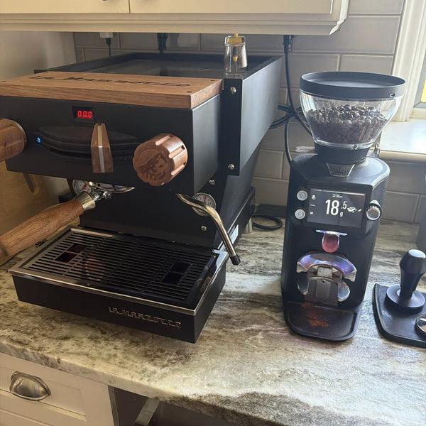 Black E64 WS beside a walnut-trimmed Linea Mini